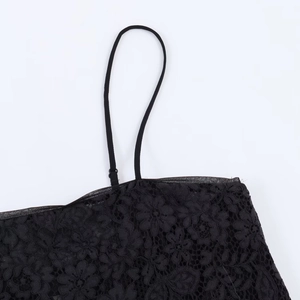 Detailed macro view of black lace floral pattern and delicate shoulder strap stitching