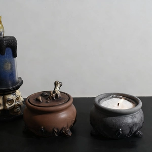 Gothic skull candle holder and bone-decorated resin jars for Halloween home decor