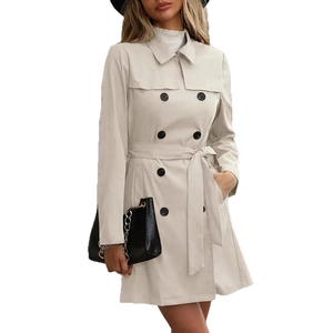 Détail du trench-coat beige à double boutonnage avec ceinture et col à revers chic