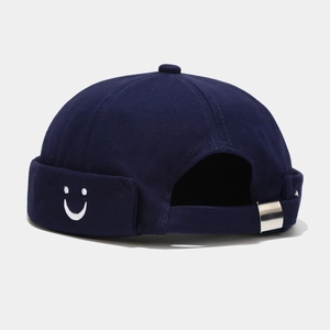 Detail of navy docker hat with smiley embroidery and adjustable metal silver buckle