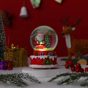 Close-up of a festive Christmas snow globe featuring Santa Claus and a Merry Christmas base