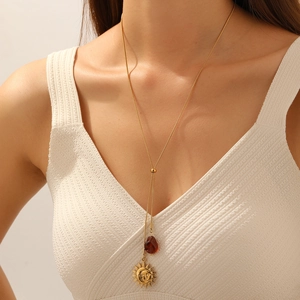 Vintage gold sun necklace with dark red drop pendant on a stylish snake chain for women
