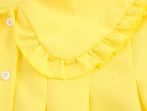 Detailed macro view of yellow blouse showing Peter Pan collar with delicate ruffled edges