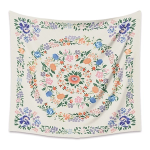 Detail of square mandala floral tapestry with rose patterns on a beige fabric background