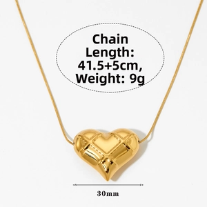 Macro shot showing dimensions of a gold checkered heart pendant with chain length details