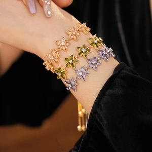 Detailansicht der geschichteten Blumen-Stern-Armbänder mit Zirkonia-Steinen am Model