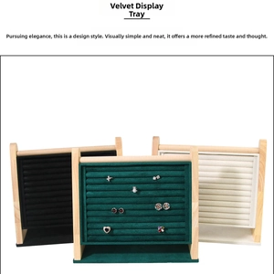Velvet jewelry display trays with wooden frames in green, black, and beige for rings