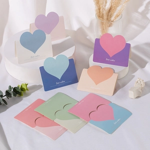Detail of colorful heart-shaped folding cards featuring Best Wishes text in soft pastel colors