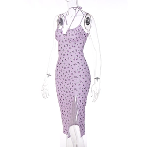 Detail view of purple floral summer dress featuring thin straps and high side slit design