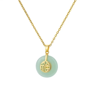 Macro detail of gold clover necklace with green jade pendant and Fu character