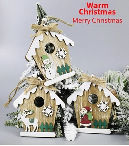 Three wooden Christmas house pendants with Santa, snowman and reindeer on snowy branches