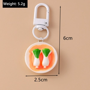 Macro detail of simulation food keychain showing spring onion plate with size markers