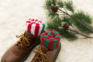 Thick Christmas coral fleece socks with reindeer motifs inside stylish brown leather boots