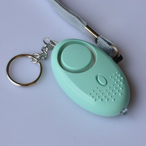 Detail view of mint green personal alarm with emergency LED light and woven lanyard