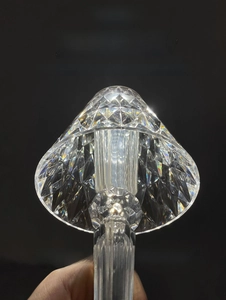 Detail of crystal diamond cut lampshade showing light refraction on modern USB desk lamp