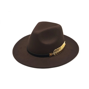 Detailed texture of brown wool felt jazz hat with gold leaf and black ribbon accent