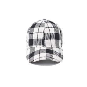 Detailed view of the black and white houndstooth fabric texture on a baseball cap