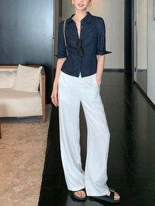 Chemise cintrée en lin bleu marine et pantalon large blanc pour un look de bureau d'été