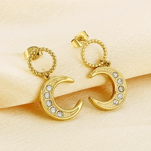 Chic gold-plated crescent moon earrings with cubic zirconia on elegant silk fabric