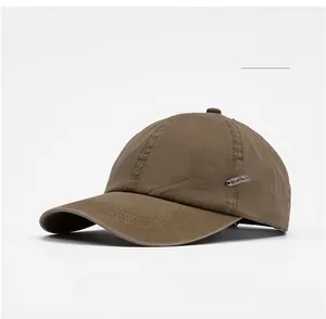 Close-up of khaki baseball cap featuring SPORT embroidery and small metal logo detail