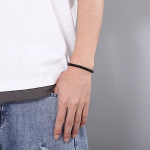 Close-up of minimalist black square link bracelet worn on a man's wrist for a stylish look