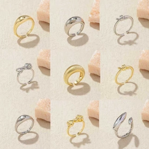 Set of nine irregular minimalist gold and silver plated rings with glossy metal textures