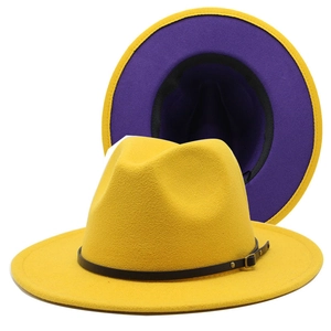 Detail of yellow wool fedora hat with purple underbrim and black leather belt buckle