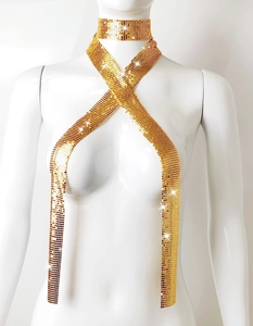 Detail of a sparkling gold sequin metal mesh body chain necklace on a white mannequin