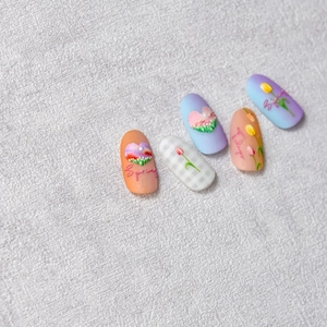 Detail of embossed tulip nail stickers with spring floral patterns and heart motifs