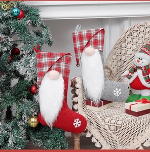 Detail of plush Christmas gnome stockings with snowflake patterns in a cozy festive setting