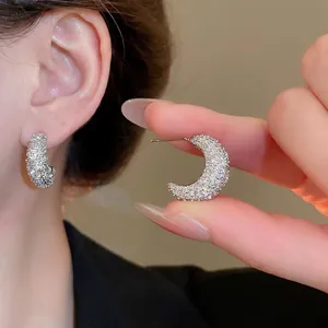 Sparkling silver moon-shaped hoop earrings with zircons for women in casual wear