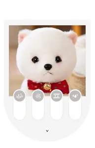 Close-up of white plush Pomeranian puppy with red plaid bow and small golden bell