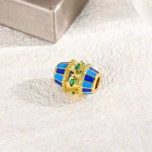 Detailed macro shot of oval enamel bead with green zircon and blue striped finish