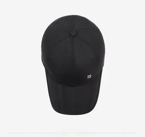 Top view of a black quilted baseball cap for men featuring a metallic geometric logo