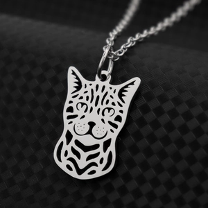 Polished leopard head pendant necklace with intricate cut-out details on black display
