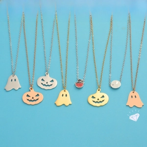 Detail of Halloween stainless steel pendants featuring ghost and pumpkin designs