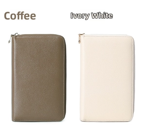 Detailed view of long zip-around leather wallets in coffee and ivory with litchi texture