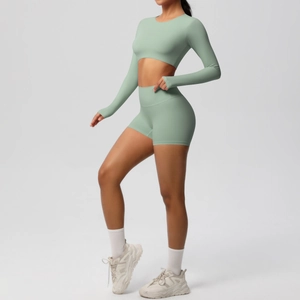 Detail of sage green yoga set featuring long-sleeved crop top and high-waisted shorts