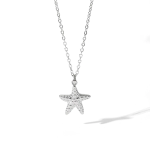 Macro shot of silver stainless steel starfish pendant necklace with detailed texture