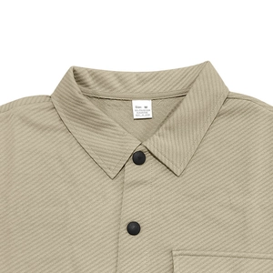 Detailed close-up of khaki twill jacket collar with matte black buttons and wash label