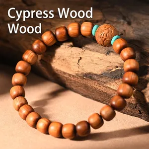 Thuja wood bracelet with blue accent beads displayed on a rustic vintage wood background