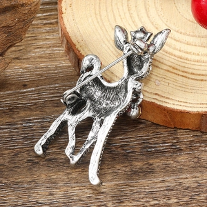 Macro view of silver vintage deer brooch back showing metal texture and pin clasp