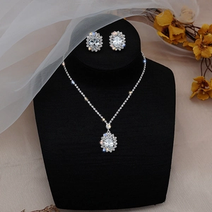 Close-up of elegant bridal jewelry set with zircon sunflower pendant on velvet stand