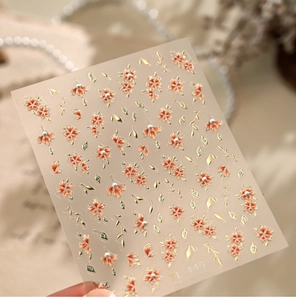 Detailed macro view of 5D embossed nail stickers featuring orange floral patterns TL449