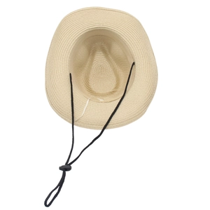 Detailed view of straw sun hat with adjustable black wind lanyard and woven texture