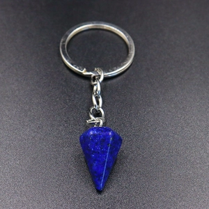 Detail of blue lapis lazuli hexagonal cone stone pendant on silver keychain ring