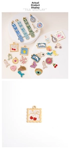 Detail showing colorful enamel pendants including fruit, flowers and bohemian hand charms