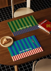 Detailed scene of waterproof leather placemats with vintage stripes and joy quotes