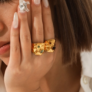 Hammered gold stainless steel rings set with natural gemstones on female model finger