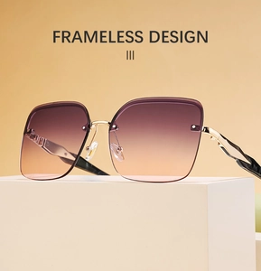 Detail of frameless sunglasses with purple gradient lenses and carved gold metal temples
